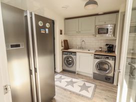 A laundry room with appliances and kitchen fixtures at Summerset Lodge in Bamburgh