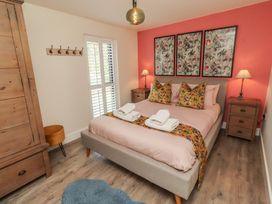 A bedroom with a bed and bedside tables at Summerset Lodge in Bamburgh