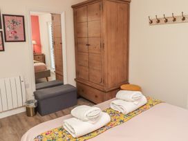 A bedroom with a wardrobe and bed at Summerset Lodge Bamburgh