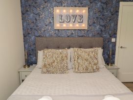 A bedroom with a bed and bedside tables at Summerset Lodge in Bamburgh