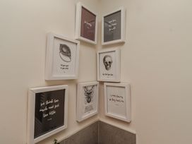 A collection of framed art on a wall at Summerset Lodge in Bamburgh
