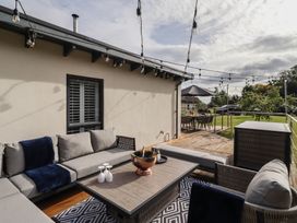 An outdoor patio with seating and table at Summerset Lodge in Bamburgh