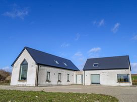 A house with multiple windows and a door at An Tobar in Ballina