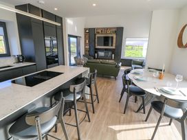 A kitchen with dining area and living space at An Tobar in Ballina