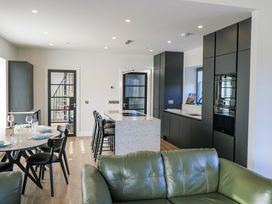 A kitchen with an island and dining table at An Tobar in Ballina
