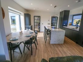 A dining room with a table and chairs at An Tobar in Ballina