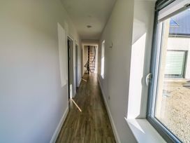 A hallway with doors and staircase at An Tobar in Ballina