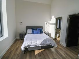 A bedroom with a bed and a bedside table at An Tobar in Ballina