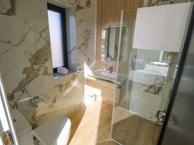 A bathroom with a shower and sink at An Tobar in Ballina