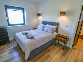 A bedroom with a bed and nightstand at An Tobar in Ballina