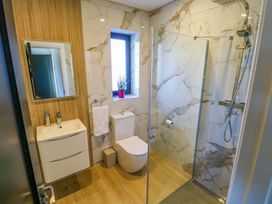 A bathroom with a sink, toilet, and shower at An Tobar in Ballina