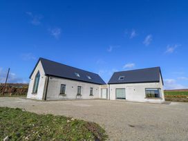 A house with multiple windows and a driveway at An Tobar in Ballina