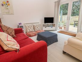 A living room with a sofa and television at Pump Cottage in Truro
