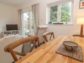 A dining room with a table and television at Pump Cottage in Truro