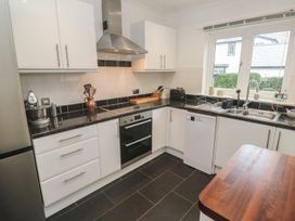 A kitchen with a sink and stove at Pump Cottage in Truro