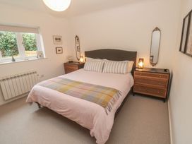 A bedroom with a bed and a dressing table at Pump Cottage in Truro