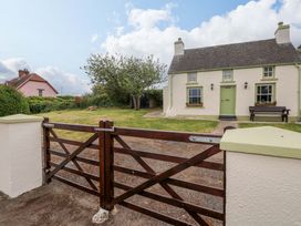 A house with a garden and a wooden gate at Beacon House Marloes near Little Haven