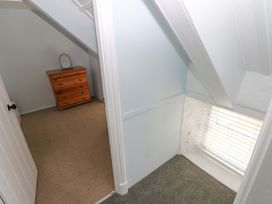 A bedroom with a dresser and a window at Beacon House Marloes near Little Haven