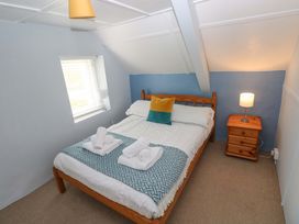 A bedroom with a bed and bedside table at Beacon House Marloes near Little Haven