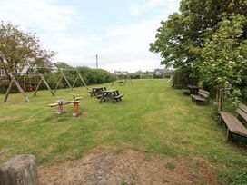 An outdoor area with swings and picnic tables at Beacon House in Marloes near Little Haven