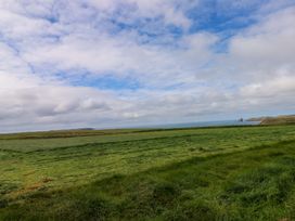 A landscape featuring grass and the ocean at Beacon House in Marloes near Little Haven