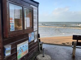 A beach cabin with information signs near the sea at Hope Cove, Kingsbridge