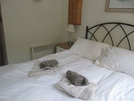 A bedroom with a bed and towels on it at Hope Cove near Kingsbridge