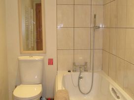 A bathroom with a toilet and a bath at Hope Cove near Kingsbridge