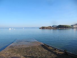 A view of boats on water with a rocky shoreline at Hope Cove near Kingsbridge