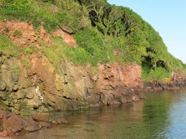 A coastal view featuring cliffs and water at Hope Cove near Kingsbridge
