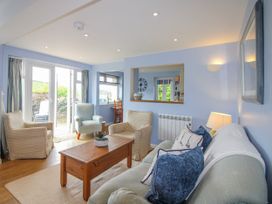 A living room with a sofa and coffee table at Quay Sands, Hope Cove