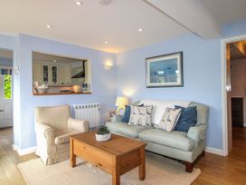 A living room with a sofa and coffee table at Quay Sands, Hope Cove