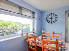 A dining room with a table and chairs at Quay Sands, Hope Cove