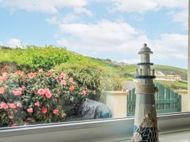 A lighthouse decoration and flowers at Quay Sands, Hope Cove