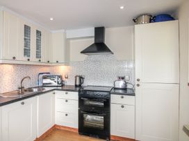 A kitchen with an oven, sink, and microwave at Quay Sands, Hope Cove