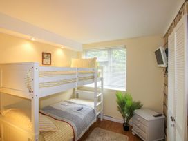 A bedroom with a bunk bed and window at Quay Sands, Hope Cove