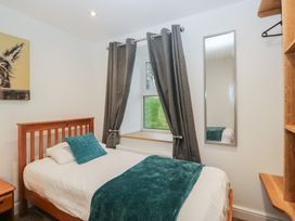 A bedroom with a single bed and a window at 6 Hallin Fell in Penrith