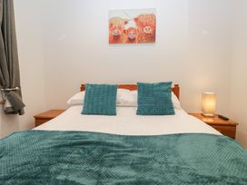 A bedroom with a bed and nightstand at 6 Hallin Fell in Penrith