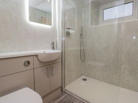 A bathroom featuring a shower, sink, and toilet at 6 Hallin Fell in Penrith
