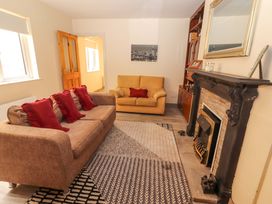 A living room with a sofa and armchair at Macmathuna, Kilrush, County Clare