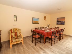 A dining room with a table set for meals at Macmathuna, Kilrush, County Clare