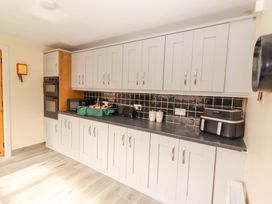 A kitchen with cabinets and countertop at Macmathuna in Kilrush, County Clare
