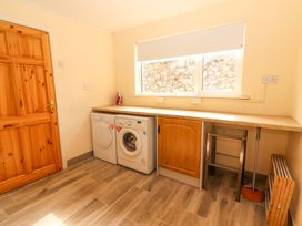 A laundry room with washing machine and tumble dryer at Macmathuna in Kilrush, County Clare