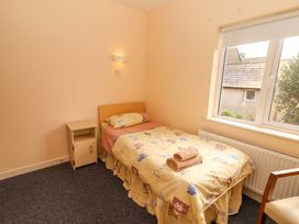 A bedroom with a bed and nightstand at Macmathuna, Kilrush, County Clare