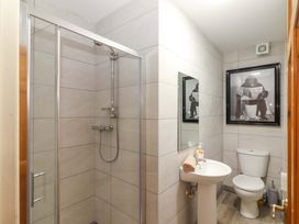 A bathroom with shower, sink, and toilet at Macmathuna in Kilrush, County Clare