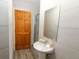 A bathroom with sink and shower enclosure at Macmathuna, Kilrush, County Clare