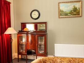 A living room with a mirror and cabinet at Macmathuna in Kilrush, County Clare