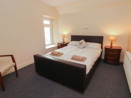 A bedroom with a bed and nightstands at Macmathuna in Kilrush, County Clare