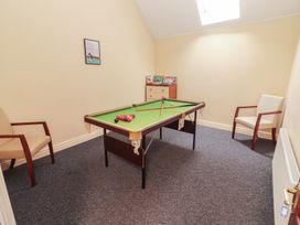 A snug with a snooker table and two chairs at Macmathuna in Kilrush, County Clare