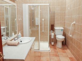 A bathroom with a shower and toilet at Macmathuna in Kilrush, County Clare